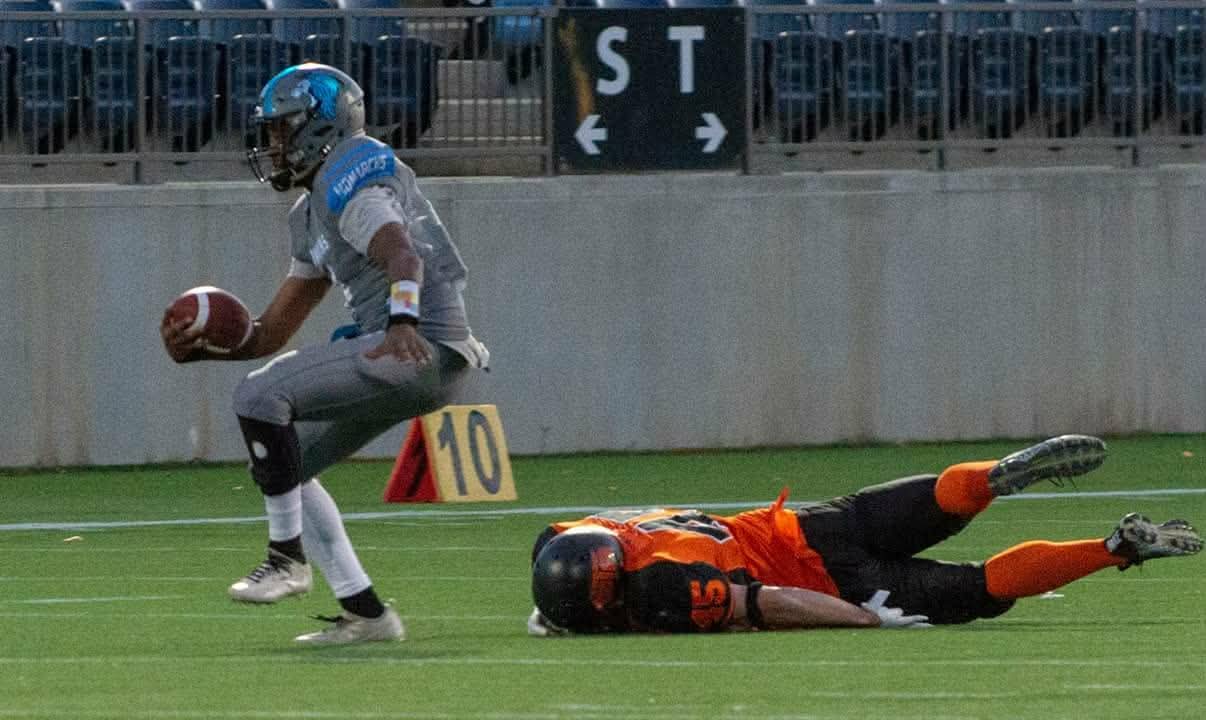 Monarchs ball carrier evading a diving tackle at the 10-yard line